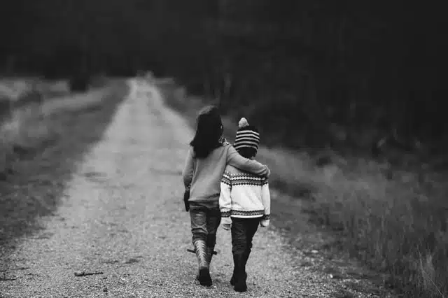 2 kids walking together - this shows good sibling relationships