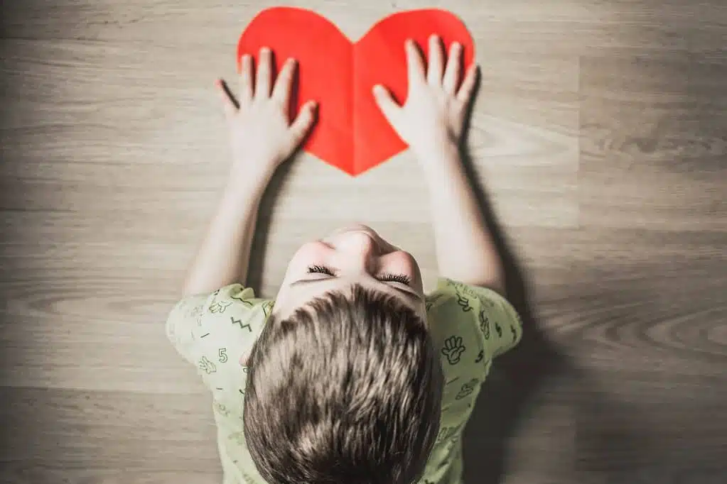 child holding heart shaped art