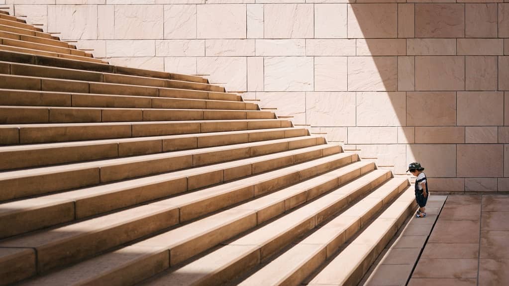 child standing in front of a stair