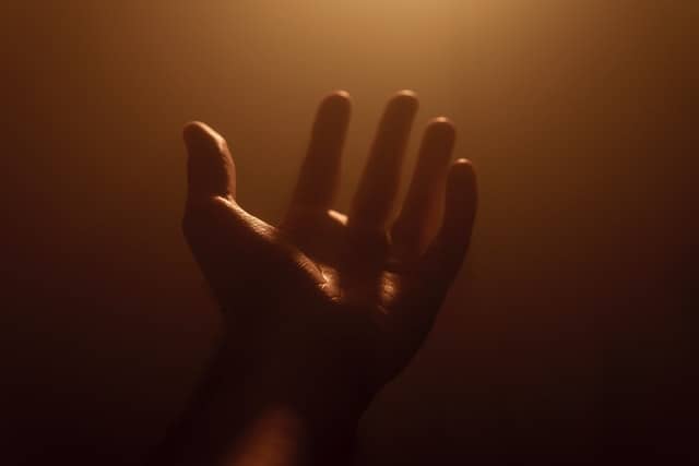 hand stretched out towards the heavens