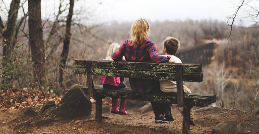 mom and her children sitting on a bench