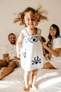 parents and baby on bed