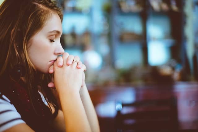 woman contemplating in pray mood