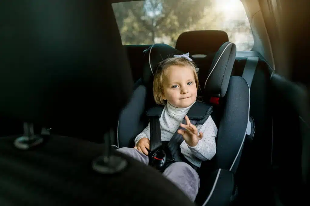 caucasian girl child sitting in safety seat