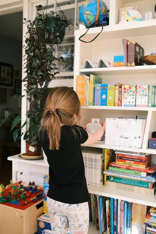 homeschool space - girl standing in front of a bookshelf
