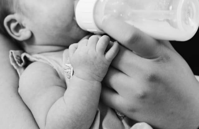 bottle feeding a baby