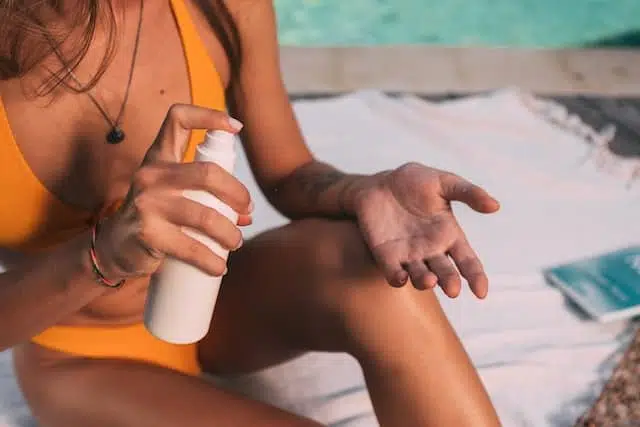 a woman holding self tanner