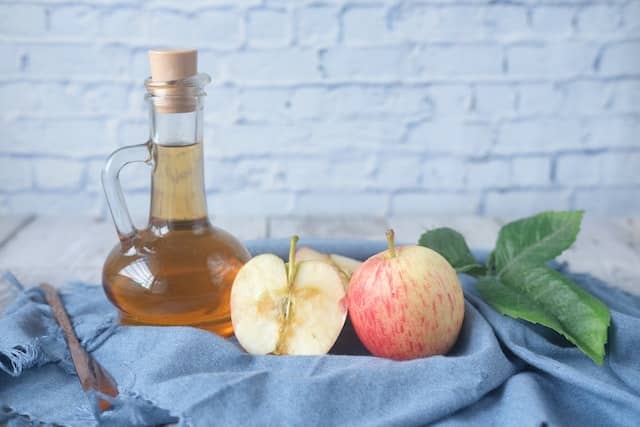 apples and apple cider vinegar on a table