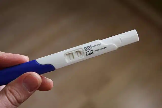 pregnancy test kit showing positive