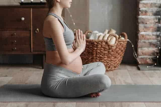 a pregnant woman meditating