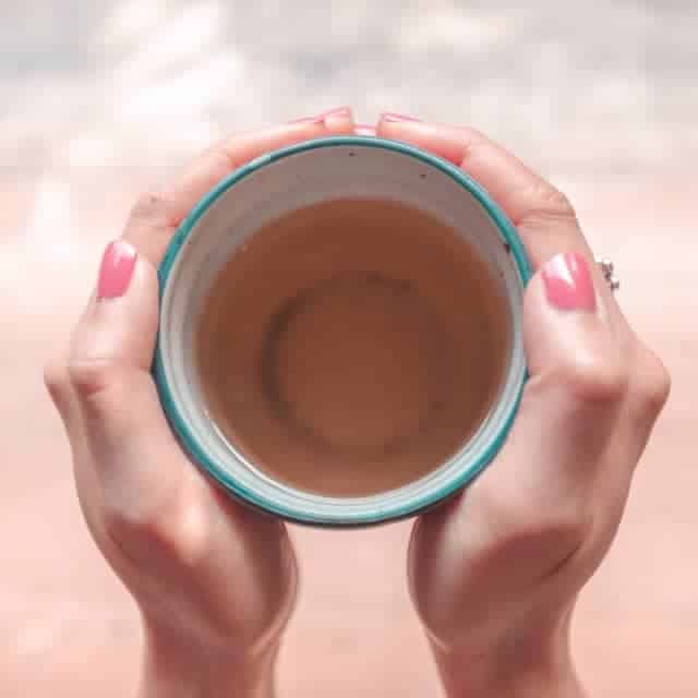 hand holding a cup of tea