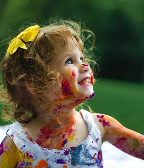 kid covered with colour paint